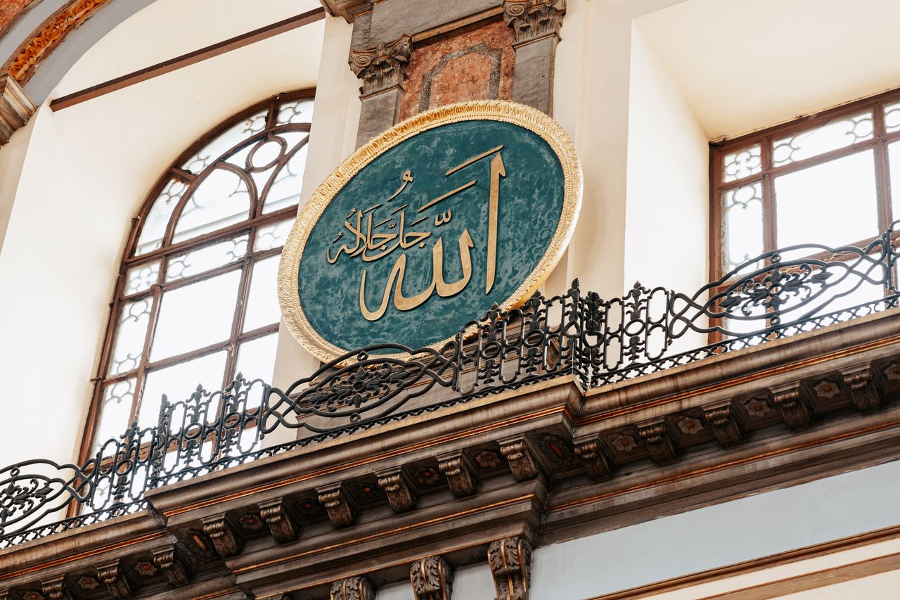 services-02 Low angle view of Arabic inscription inside Dolmabahce Mosque, Istanbul, showcasing Islamic art.
